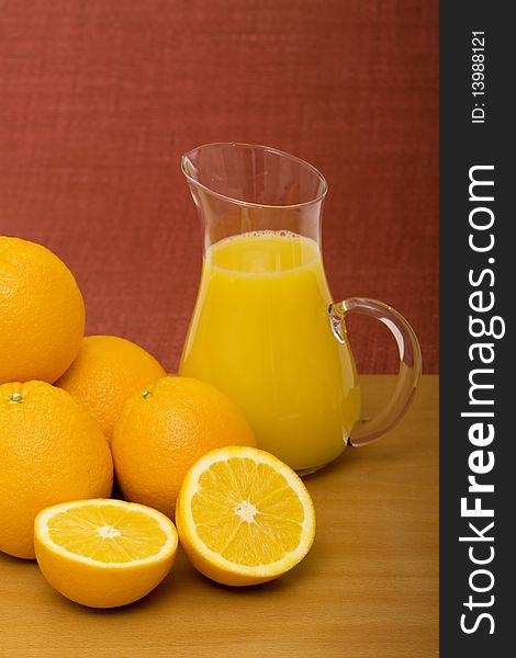 Pitcher of orange juice and oranges. Pitcher of orange juice and oranges