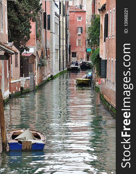 Photo of a boat on one of the many channels of Venice. Photo of a boat on one of the many channels of Venice