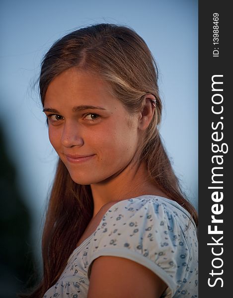 Pretty teen girl in evening light looking at camera. Pretty teen girl in evening light looking at camera