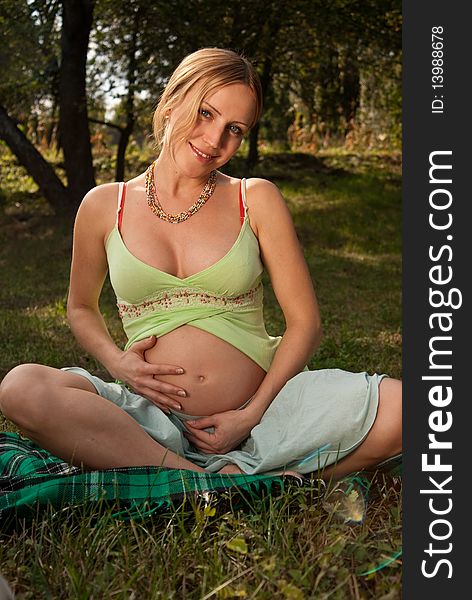 Pregnant Woman On A Grass