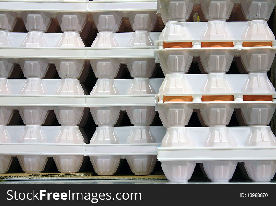 White cartons of eggs in column. White cartons of eggs in column