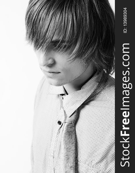 Close-up portrait of young man on light grey background