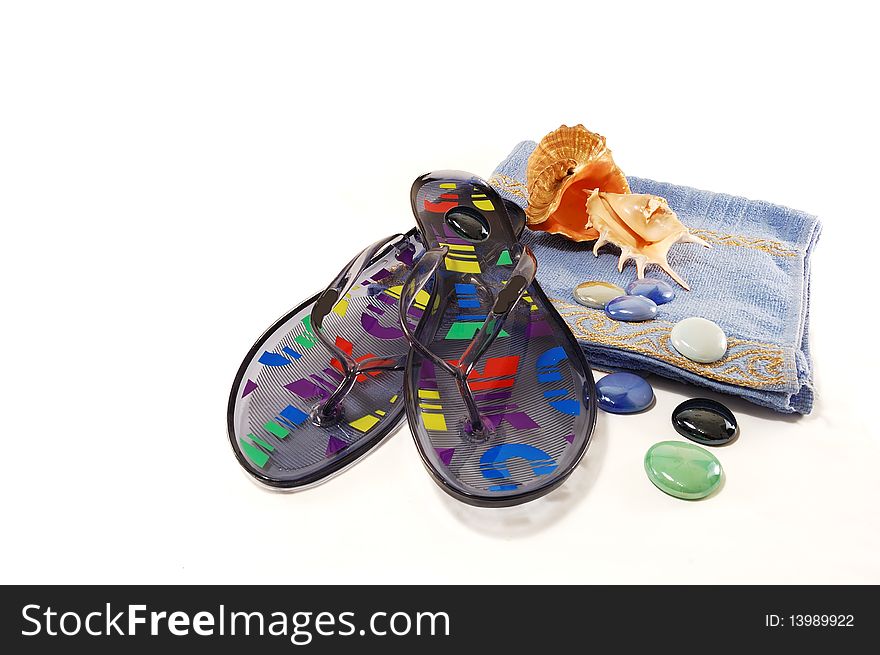 Beach slippers, towel, sea shells isolated on a white background. Beach slippers, towel, sea shells isolated on a white background