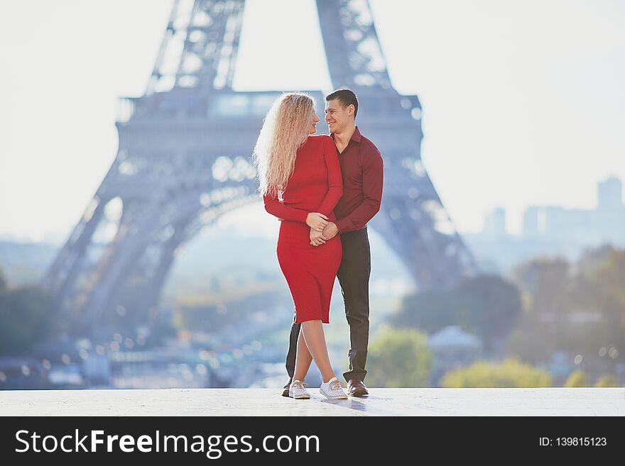 Romantic couple in love near the Eiffel tower in Paris, France