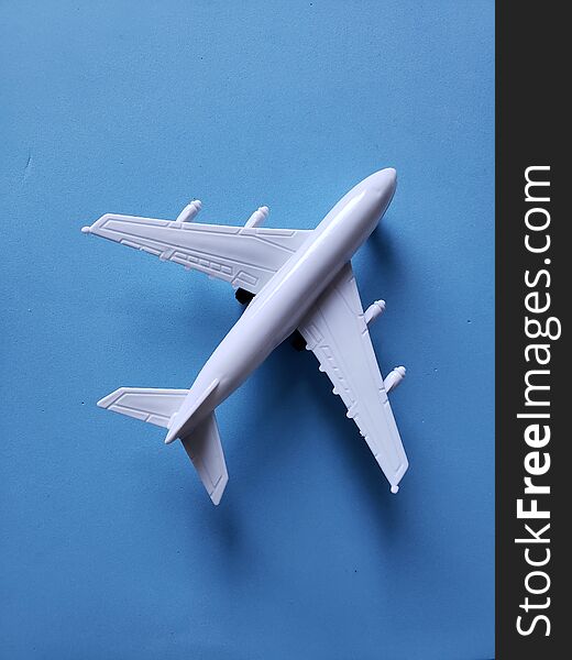 white plastic airplane and blue background