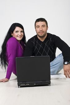 Couple Using Laptop On Wooden Floor Stock Images Couple Using Laptop On Wooden Floor Stock Images