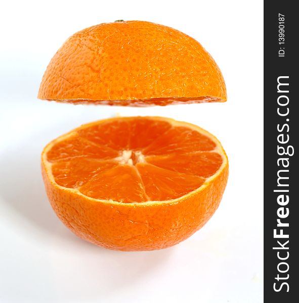 A clementine that has been cut in half and separated. A clementine that has been cut in half and separated.