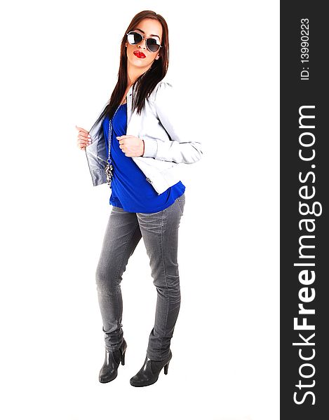 A young smiling woman in a blue sweater and light gray leather jacket pulling down her sunglasses, standing for white background. A young smiling woman in a blue sweater and light gray leather jacket pulling down her sunglasses, standing for white background.