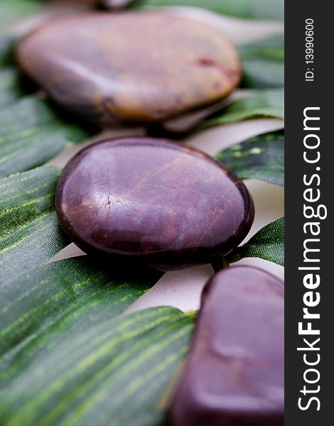 Stones on green leaf for relaxing and peace.