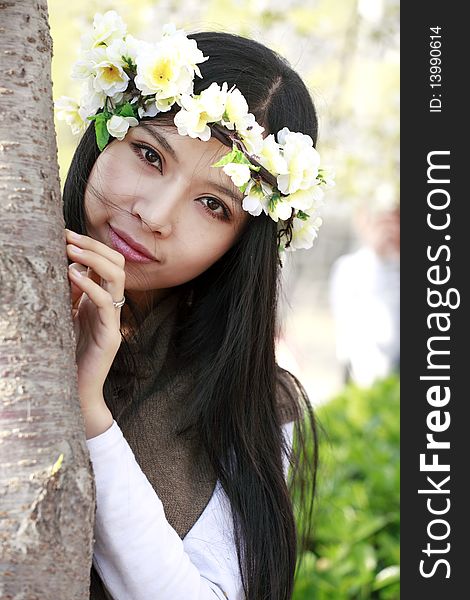 Spring portrait of young smiling girl with garlands outdoors. Spring portrait of young smiling girl with garlands outdoors.