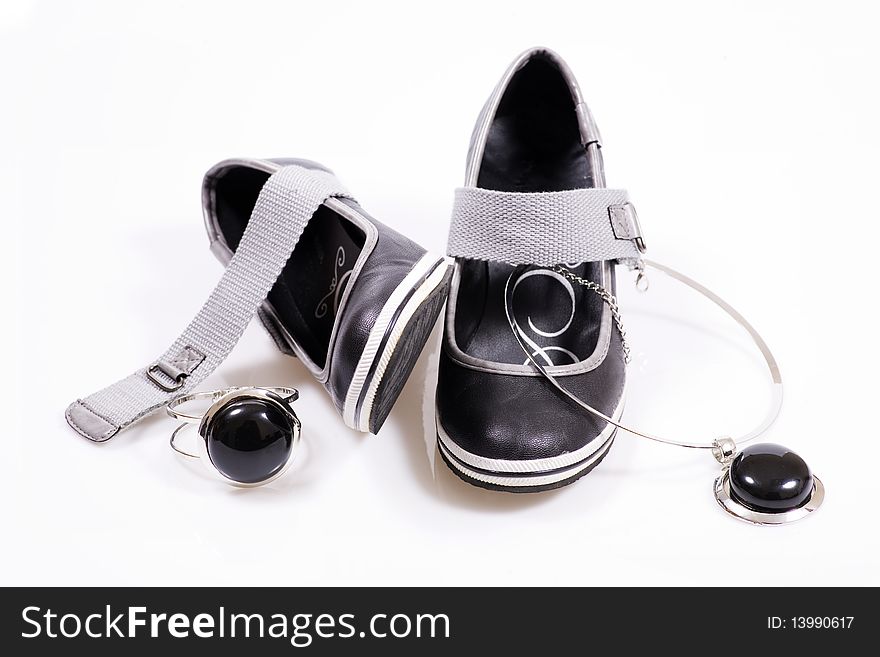 Shoe with black stones on white. Shoe with black stones on white.