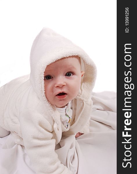 Beautiful baby girl in bathrobe on white background
