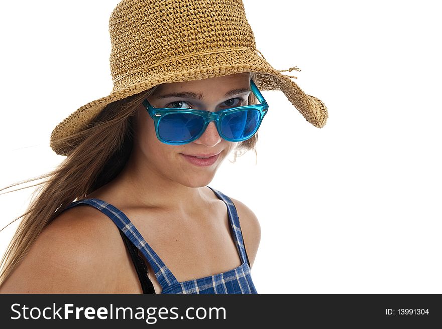 Pretty teen girl in blue sunglasses and a straw hat. Pretty teen girl in blue sunglasses and a straw hat