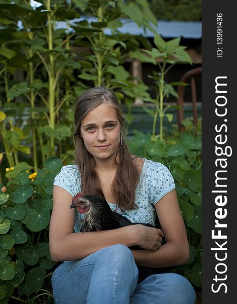 Attractive teenage girl holding a chicken. Attractive teenage girl holding a chicken