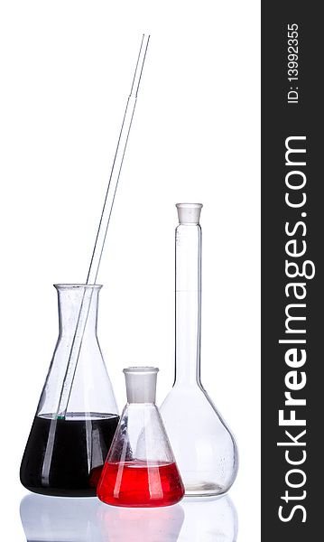 Chemical flasks with colored liquid & powder on a white background