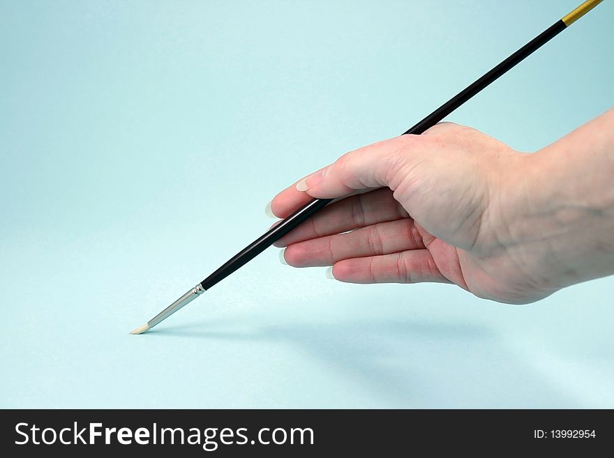 Closeup of hand and artist brush