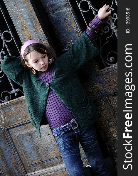 One child portrait with old door in background. One child portrait with old door in background