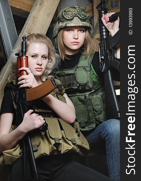 Beautiful girls in military camoflage with paintball gun;. Beautiful girls in military camoflage with paintball gun;