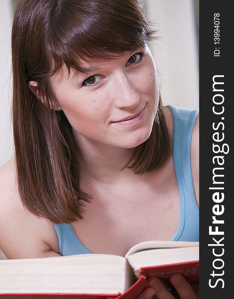 Portrait of young woman sitting with a book. Portrait of young woman sitting with a book