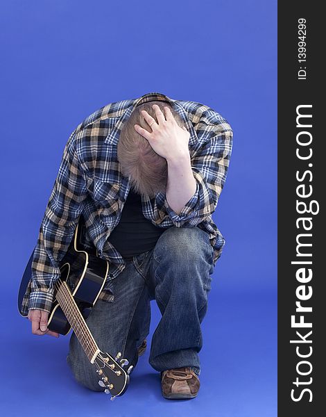 Studio portrait of a tired and depressed guitarist. Studio portrait of a tired and depressed guitarist