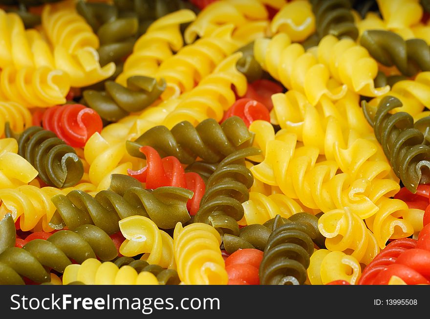 Closeup of raw multicolour pasta, food background