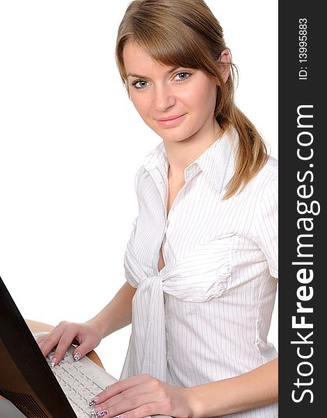 Business woman portrait smiling in front of her desktop computer.