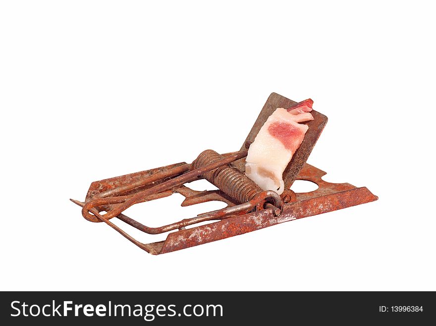 Old rusty mousetrap with bacon as a bait isolated on white