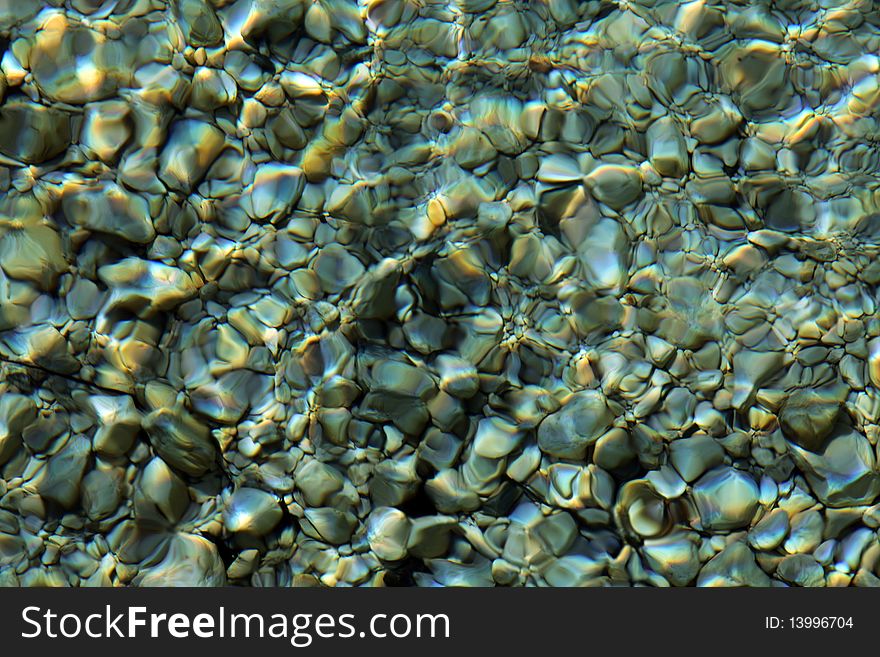 Colorful stones under water, with water effect over them. Colorful stones under water, with water effect over them
