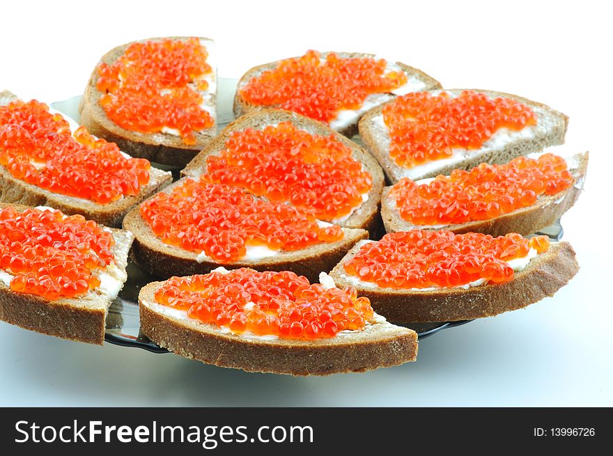 Bread with butter and red caviar on a plate. Bread with butter and red caviar on a plate