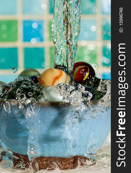 Marbles in a dish with water splashing