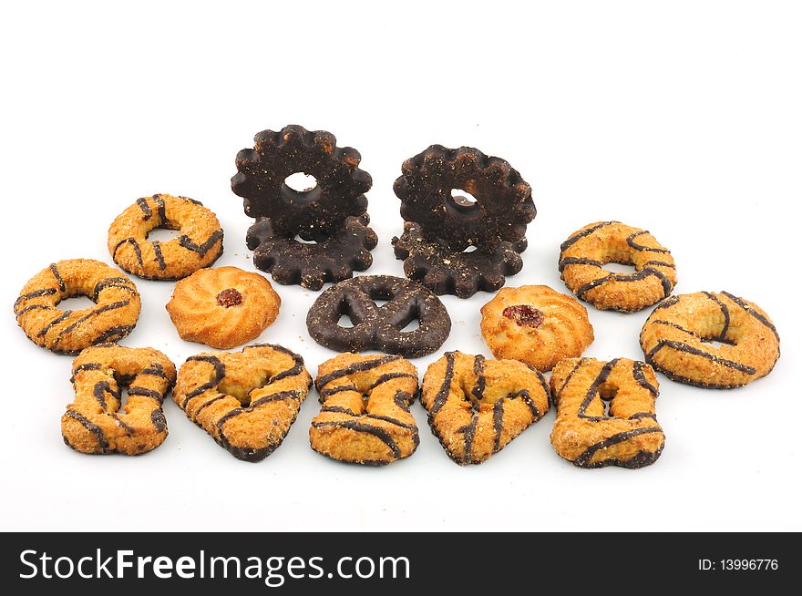 Biscuits of different forms of chocolate icing, against a white background. Biscuits of different forms of chocolate icing, against a white background