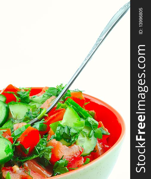Salad of tomatoes and cucumbers in a ceramic bowl on a white background. Salad of tomatoes and cucumbers in a ceramic bowl on a white background