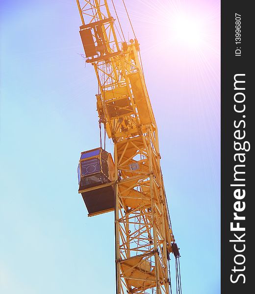 Construction crane in the sunshine. Bottom view