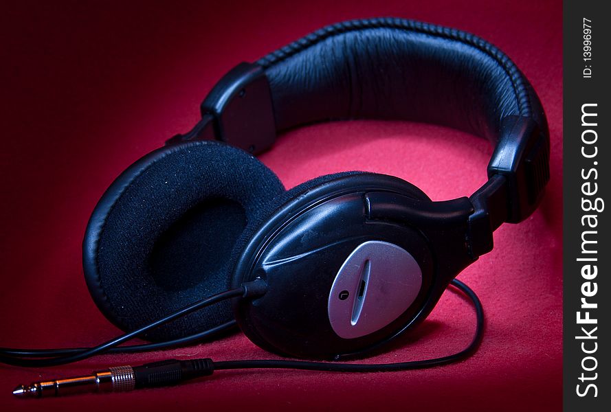 Black Headphones On A Red Background