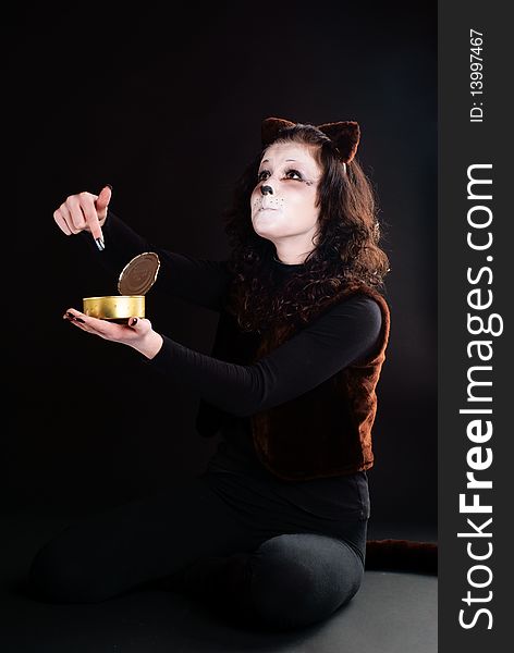 Portrait of a cat girl with an empty can. Studio shot. Portrait of a cat girl with an empty can. Studio shot.