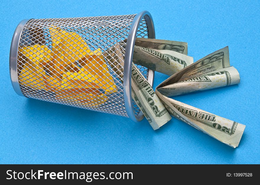 Trash Can with American Money Thrown Away on Blue Background. Trash Can with American Money Thrown Away on Blue Background.