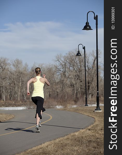 Woman jogging on city path