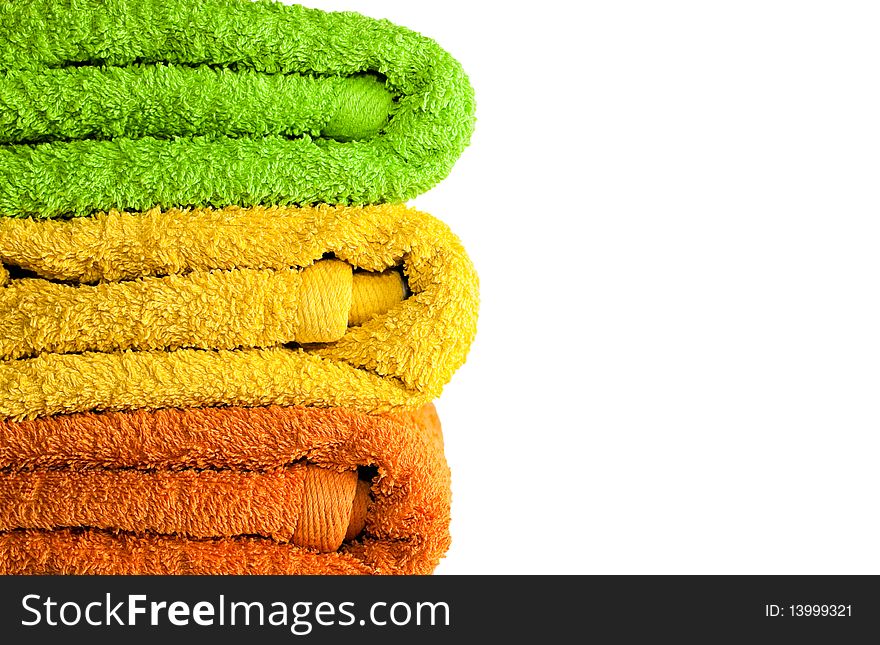 Stacked colorful towels isolated on a white background. Stacked colorful towels isolated on a white background.