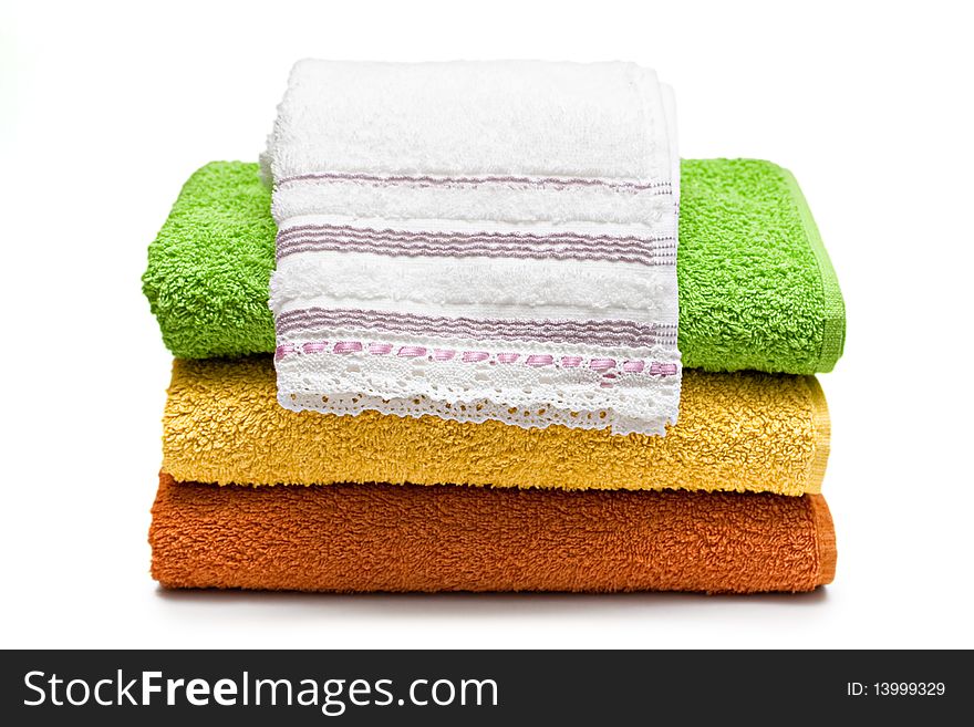 Stacked colorful towels isolated on a white background. Stacked colorful towels isolated on a white background.