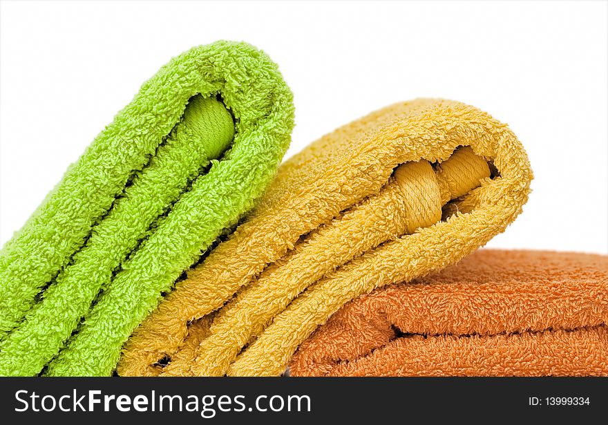 Stacked colorful towels isolated on a white background. Stacked colorful towels isolated on a white background.