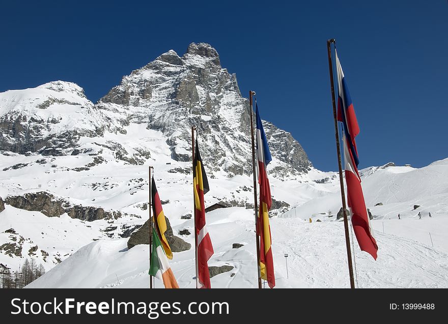 Picture of mount Cervino with international flags in a sunny day. Picture of mount Cervino with international flags in a sunny day