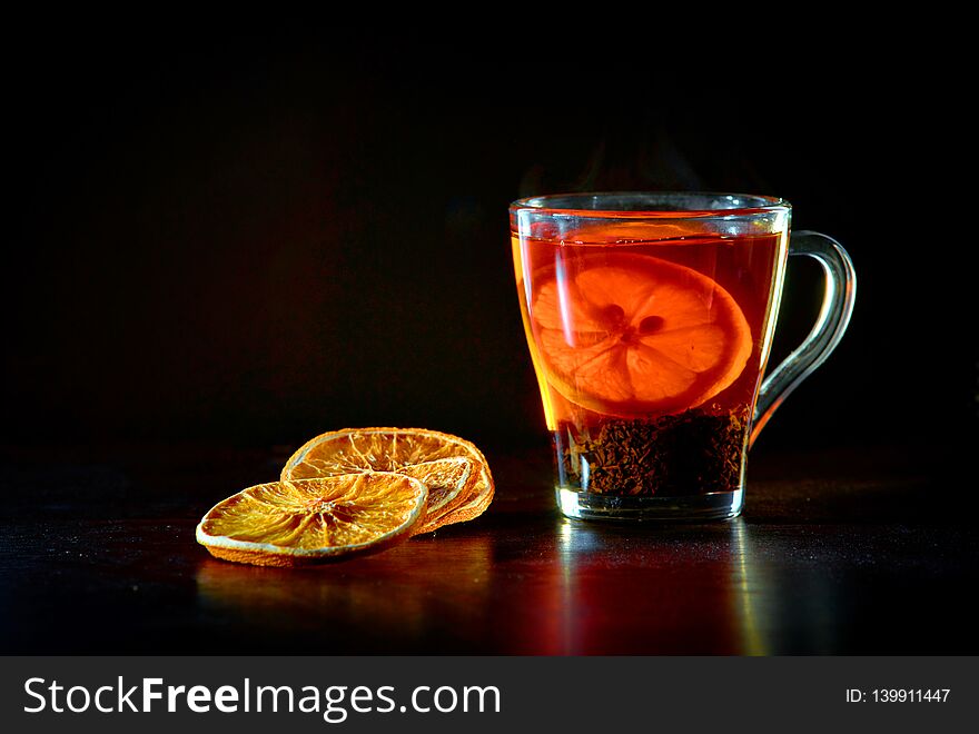 A Cup Of Black Tea And Lemon, Pieces Of Dried Orange.