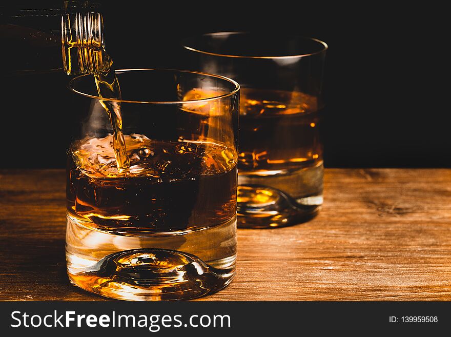 Whiskey glass and whiskey with ice cube