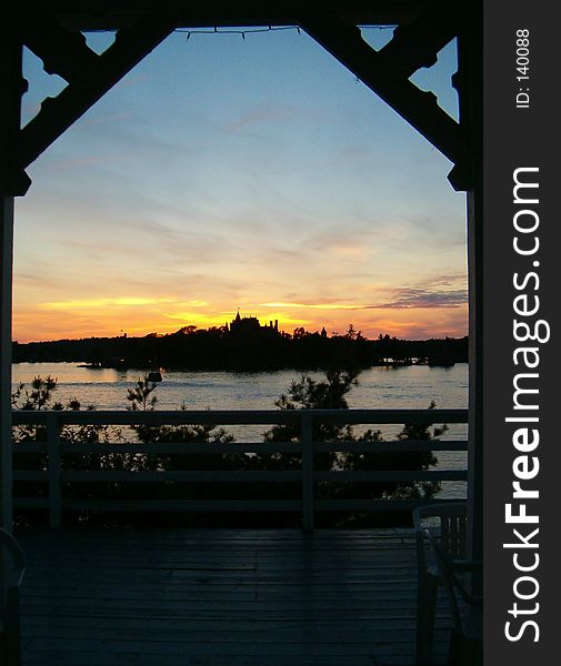 Boldt Castle silhouetted in the sunset framed by the arch of a Gazebo on Lake Ontario. Boldt Castle silhouetted in the sunset framed by the arch of a Gazebo on Lake Ontario.