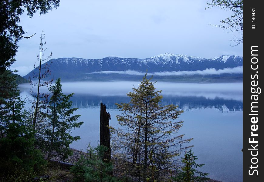 Lake McDonald at dusk in Glacier National Park, with a fog bank rolling over the lake. Lake McDonald at dusk in Glacier National Park, with a fog bank rolling over the lake.