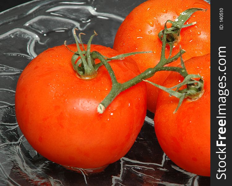 Three tomatoes on a plate