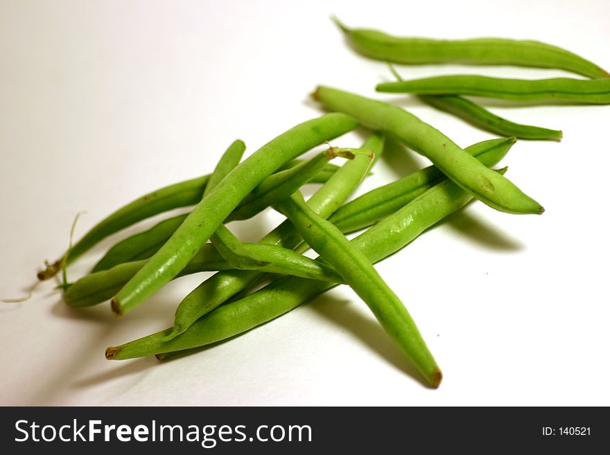 Bunch of green beans on a white background.