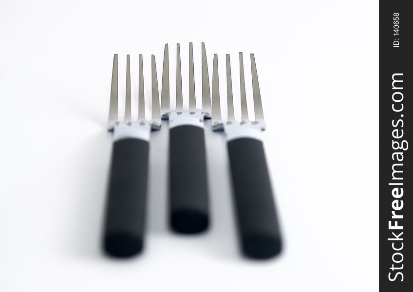 Three forks against a white background