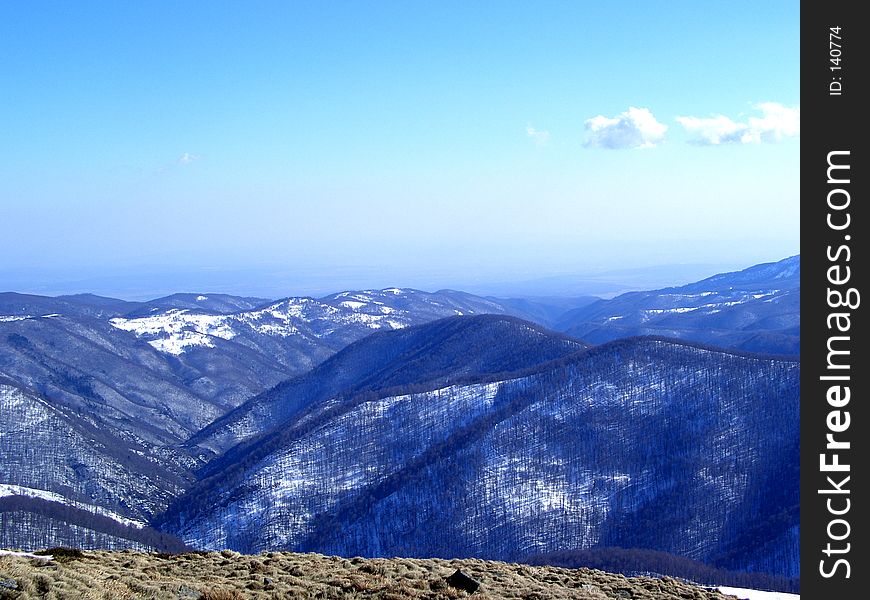Here are some mountains in Romanian full of snow and trees. Here are some mountains in Romanian full of snow and trees.