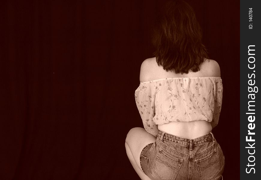 woman with long hair is squatting down. She is turned away from the viewer, wearing denim mini skirt and see thru blouse off the shoulders. copy space. Exclusive. woman with long hair is squatting down. She is turned away from the viewer, wearing denim mini skirt and see thru blouse off the shoulders. copy space. Exclusive.